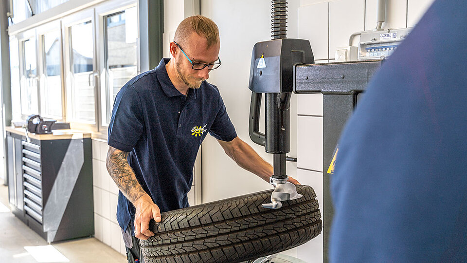 Camperland Bong Mitarbeiter prüft Profiltiefe bei Reifen